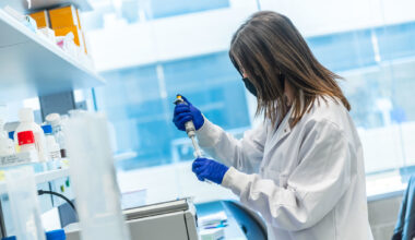 female trainee using a pipette in the lab