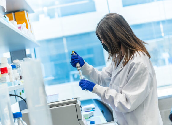 female trainee using a pipette in the lab